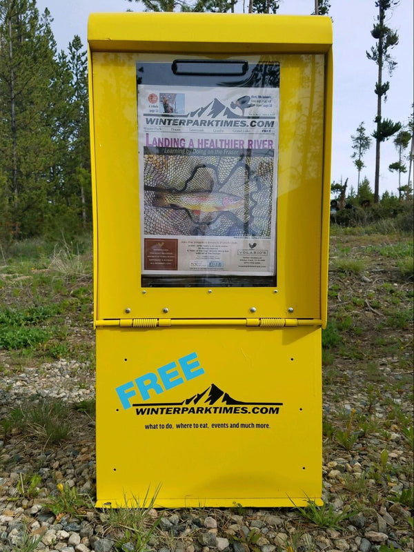 Yellow newpaper box used to dispense publications.